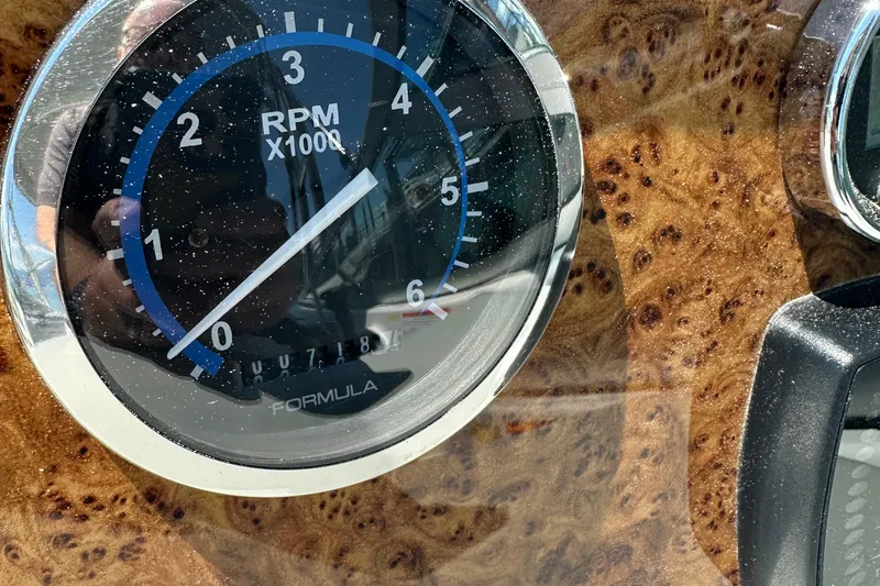 Slide: The Image of Tachometer of 2007 Formula 260 Bowrider boat on wood grain dashboard. - 10