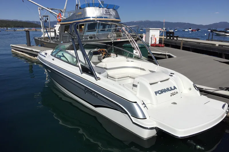 Slide: The Image of 2007 Formula 260 Bowrider docked at marina, clear sky, calm water. - 3