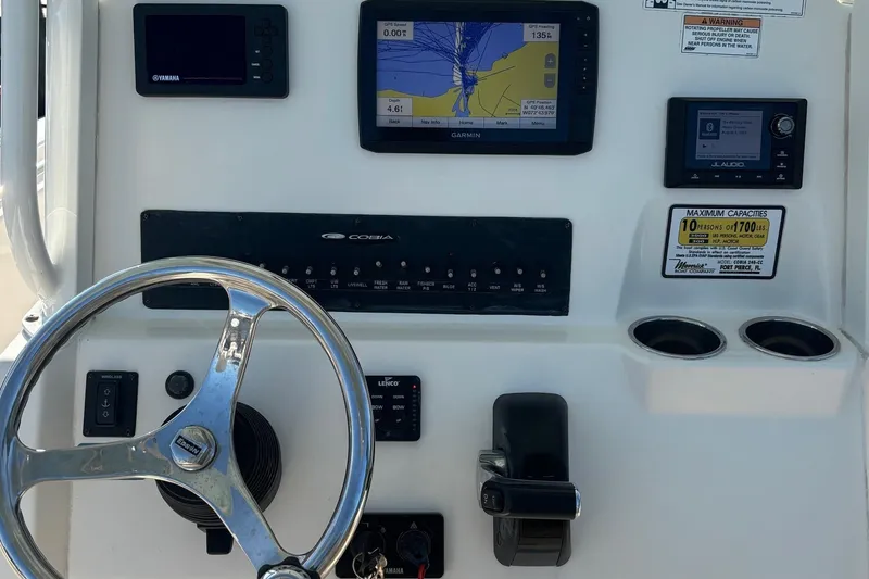 Slide: The Image of 2019 Cobia 240 Center Console dashboard with steering wheel, navigation, and control panels. - 3