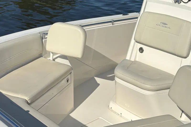 Slide: The Image of 2019 Cobia 240 Center Console boat interior with cushioned seating and storage. - 6