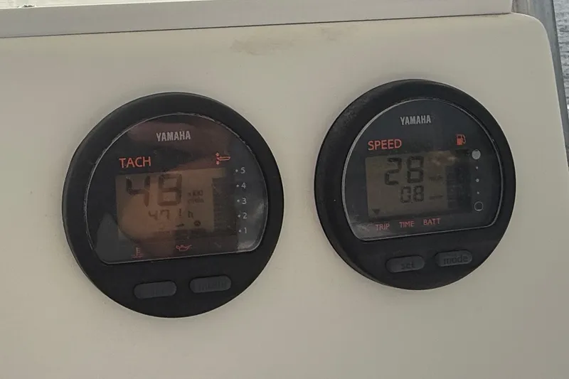 Slide: The Image of Yamaha tachometer and speedometer on a 2000 Regulator 23 Classic boat dashboard. - 13