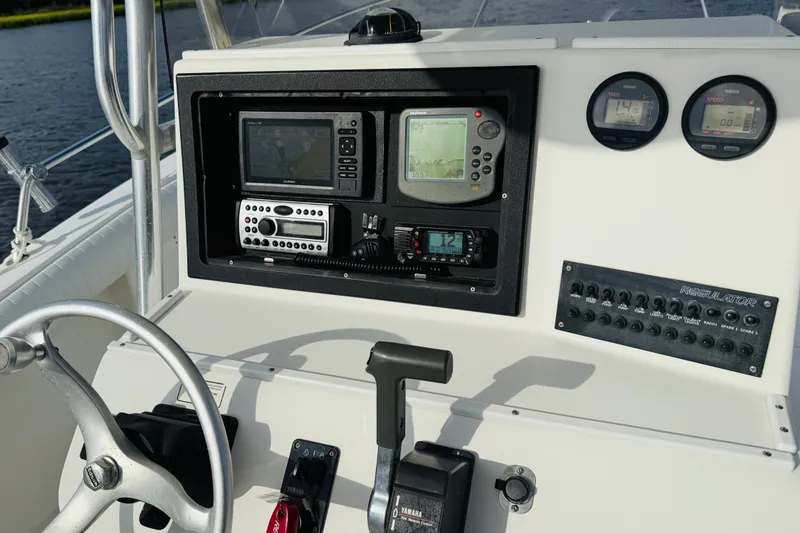 Slide: The Image of Control panel of a 2000 Regulator 23 Classic boat with navigation and communication equipment. - 14