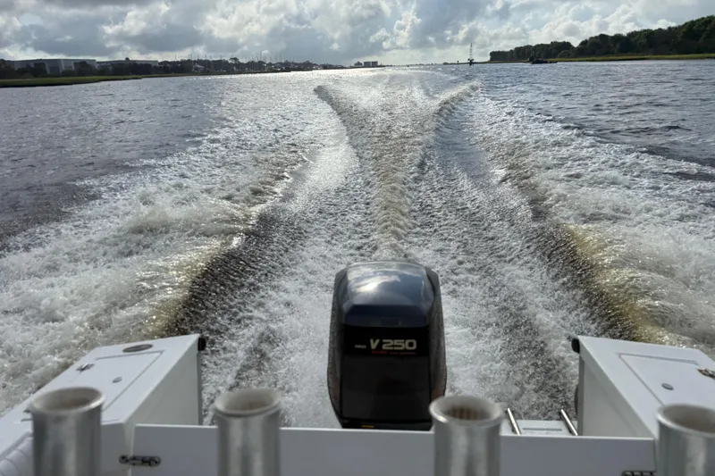 Slide: The Image of Regulator 23 Classic boat creating wake on a cloudy day, rear view. - 15
