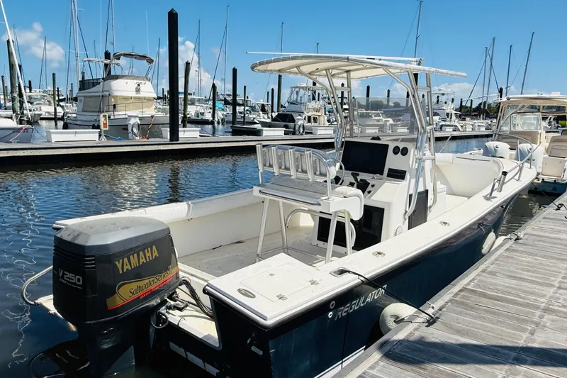Slide: The Image of 2000 Regulator 23 Classic boat docked with Yamaha V250 engine. - 4
