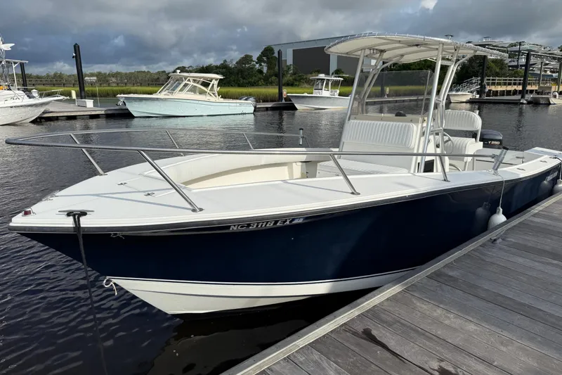Slide: The Image of 2000 Regulator 23 Classic boat docked at marina under cloudy sky. - 7