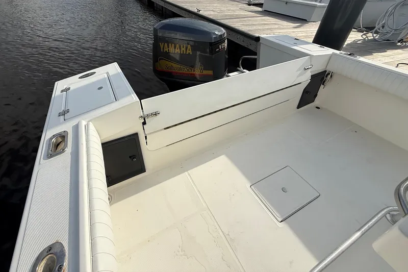 Slide: The Image of 2000 Regulator 23 Classic boat with Yamaha outboard engine at dock. - 8