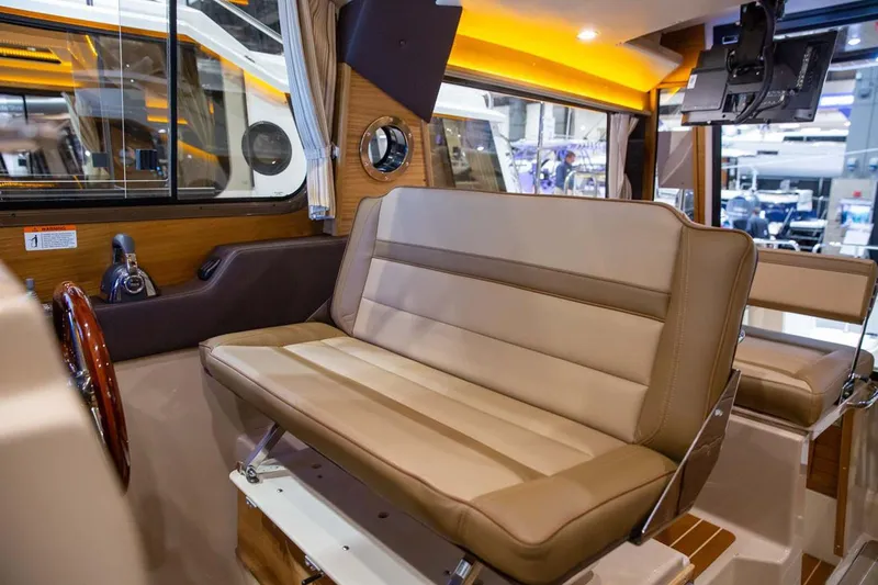Slide: The Image of Manufacturer Provided Image: Interior of 2025 Ranger Tugs R-29 S with beige seating and modern design. - 11
