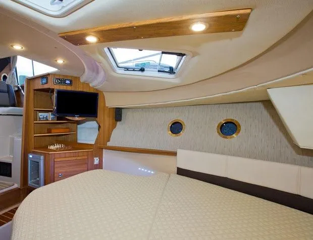 Slide: The Image of Manufacturer Provided Image: Interior of 2025 Ranger Tugs R-29 S, featuring cozy cabin with skylight and entertainment area. - 14