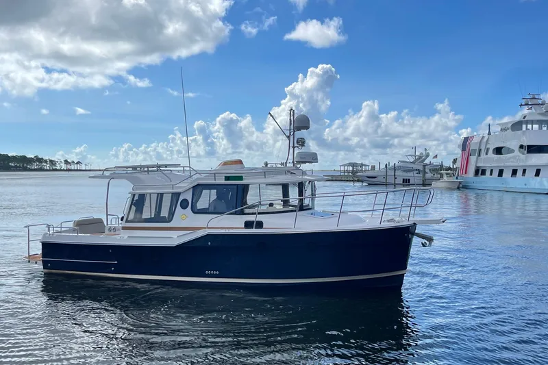 Slide: The Image of 2026 Ranger Tugs R-29 S boat on calm water under a blue sky. - 4