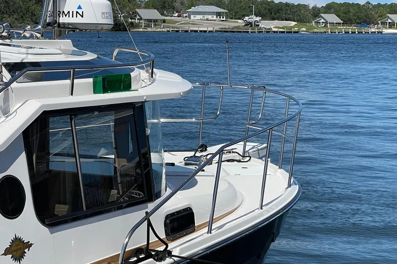 Slide: The Image of 2026 Ranger Tugs R-29 S boat docked on calm water, featuring sleek design and modern equipment. - 7