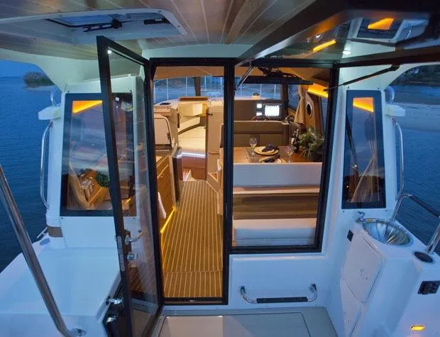 Slide: The Image of Manufacturer Provided Image: Interior view of 2025 Ranger Tugs R-29 S, featuring modern design and ambient lighting. - 8