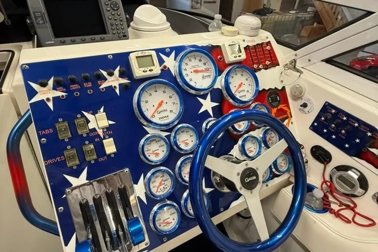 Slide: The Image of Dashboard of a 2004 Fountain 42 Lightning boat with patriotic star design and gauges. - 7