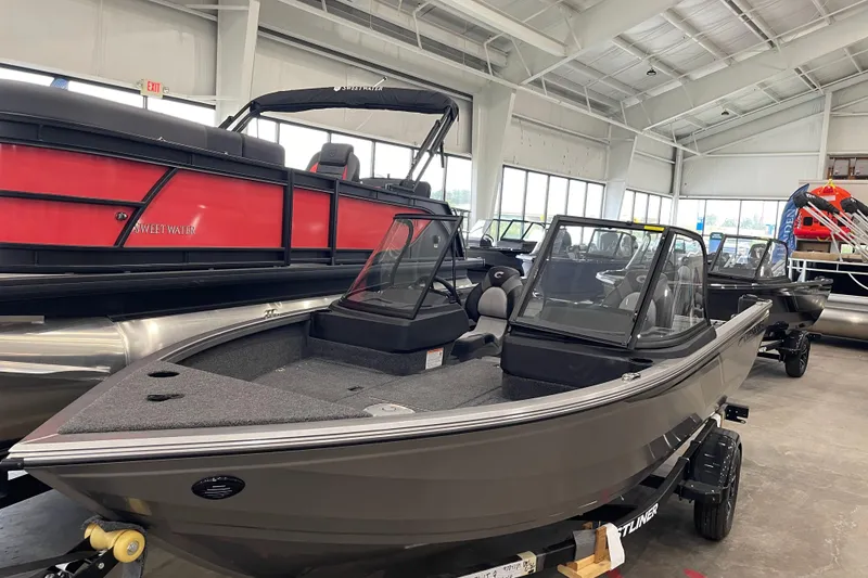The Image of 2026 Crestliner 1750 Hawk WT J boat displayed in a showroom. - 0