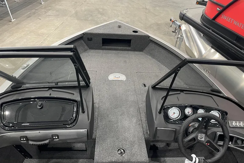 Slide: The Image of 2026 Crestliner 1750 Hawk WT J boat interior with steering wheel and dashboard. - 11