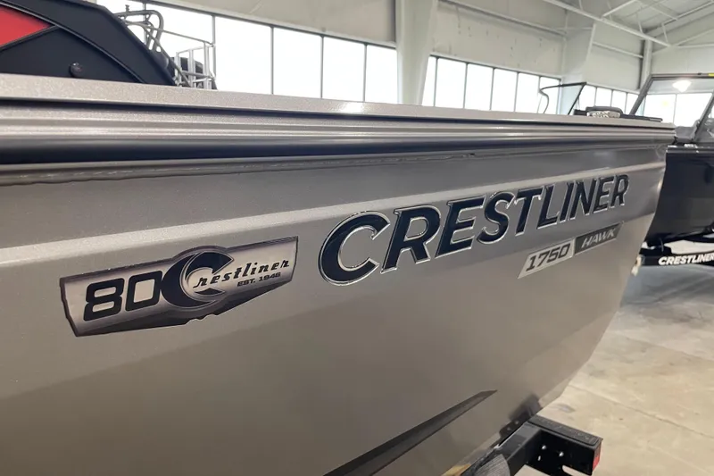 Slide: The Image of 2026 Crestliner 1750 Hawk WT J boat in showroom, showcasing sleek design and branding. - 18