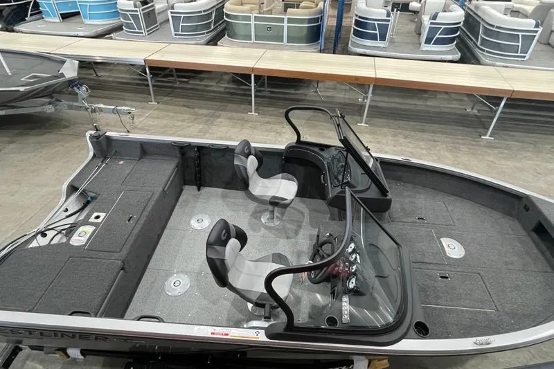 Slide: The Image of 2026 Crestliner 1750 Hawk WT J boat interior with seating and control panel. - 2