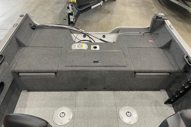 Slide: The Image of 2026 Crestliner 1750 Hawk WT J boat interior with gray carpet and storage compartments. - 4