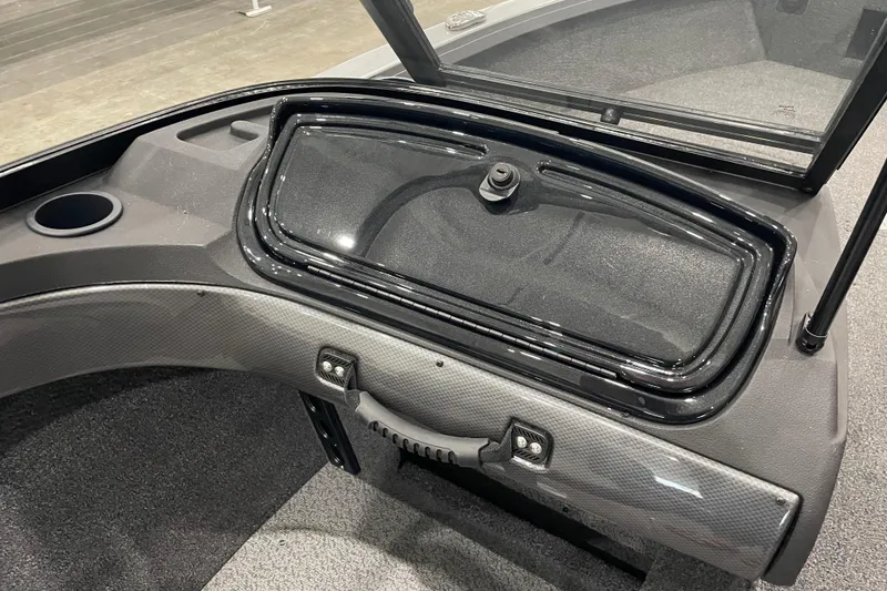 Slide: The Image of 2026 Crestliner 1750 Hawk WT J boat dashboard with storage compartment and cup holder. - 7