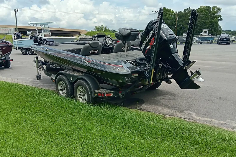 Slide: The Image of 2018 Triton 18 TrX boat with Mercury engine on a trailer in a parking lot. - 5