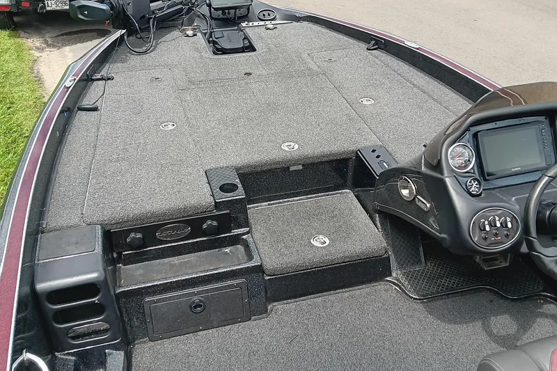 Slide: The Image of 2018 Triton 18 TrX boat interior with dashboard and carpeted deck. - 8