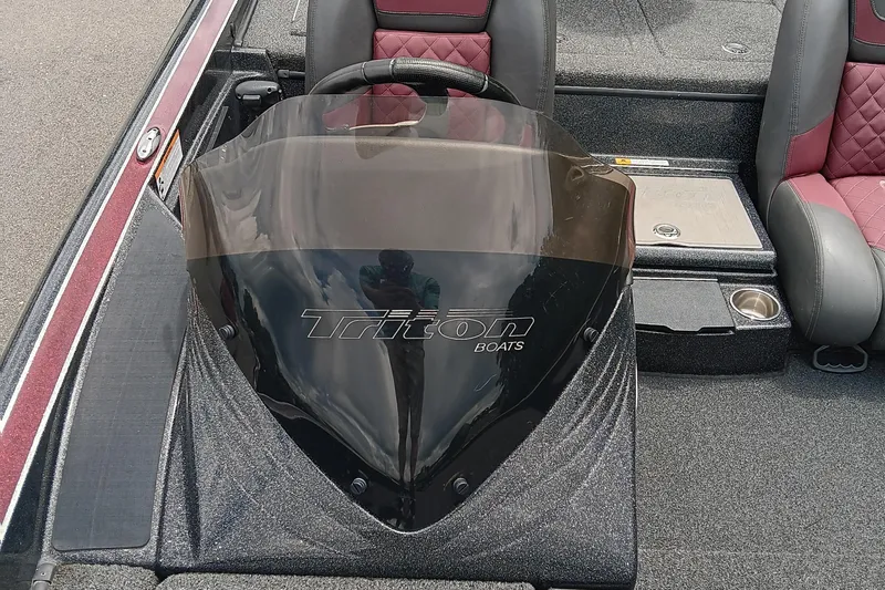 Slide: The Image of 2018 Triton 18 TrX boat interior with steering wheel and seats. - 9