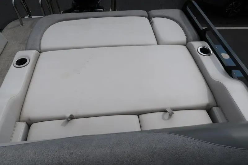 Slide: The Image of 2022 Avalon 26 LSV VRB boat interior with cushioned seating and cup holders. - 23