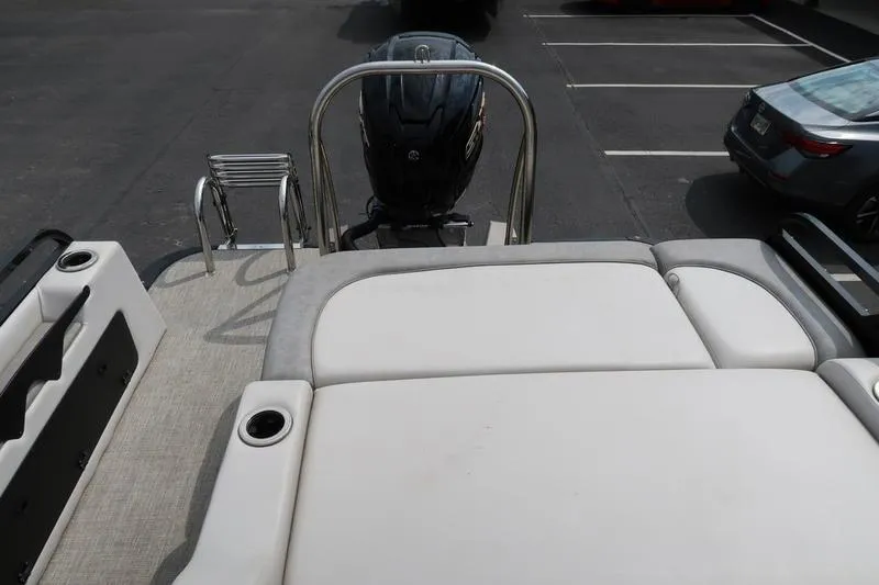 Slide: The Image of 2022 Avalon 26 LSV VRB boat with outboard motor and rear seating area. - 24