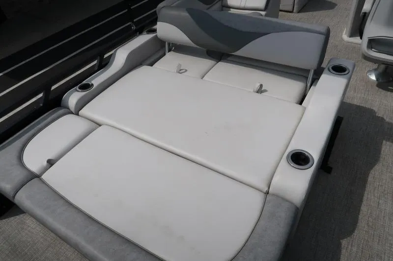 Slide: The Image of 2022 Avalon 26 LSV VRB boat interior with gray cushioned seating and cup holders. - 25