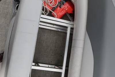 Slide: The Image of 2022 Avalon 26 LSV VRB boat interior with storage compartment and safety equipment. - 6