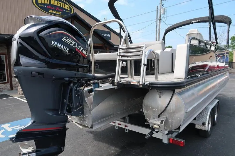 Slide: The Image of 2022 Avalon 26 LSV VRB pontoon boat with Yamaha engine, parked at a marine dealership. - 7