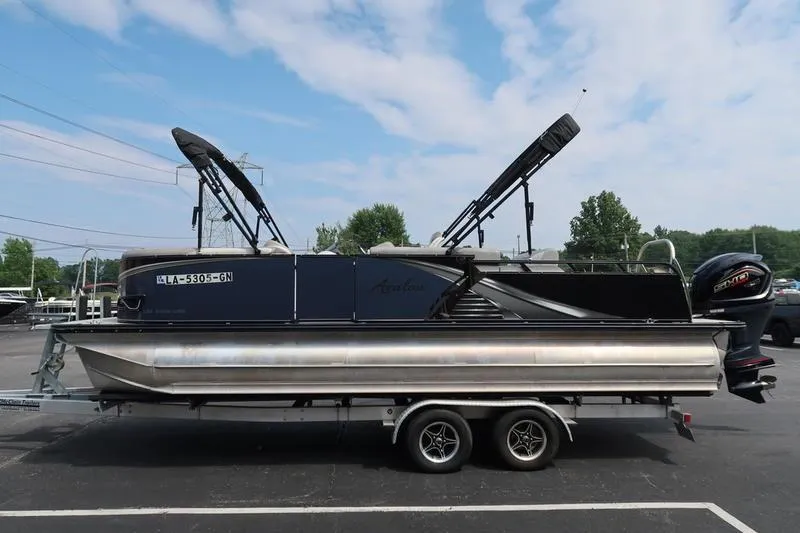 Slide: The Image of 2022 Avalon 26 LSV VRB pontoon boat on trailer, parked outdoors. - 8