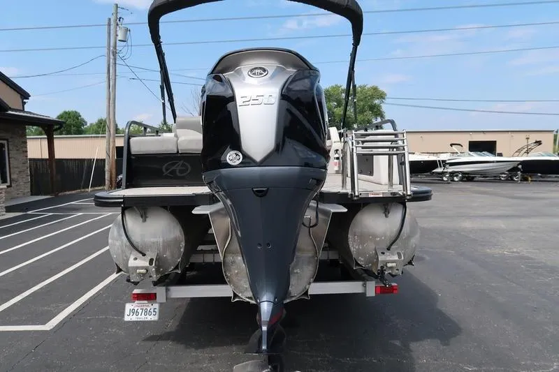 Slide: The Image of 2022 Avalon 26 LSV VRB pontoon boat with powerful outboard motor, parked in a lot. - 9