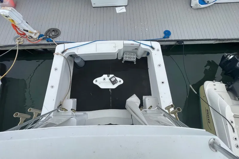 Slide: The Image of 1997 Luhrs 36 SX boat docked, viewed from above, showing deck and surrounding water. - 10