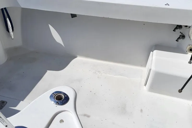 Slide: The Image of 1997 Luhrs 36 SX boat deck, featuring clean white surface and fishing rod holder. - 11