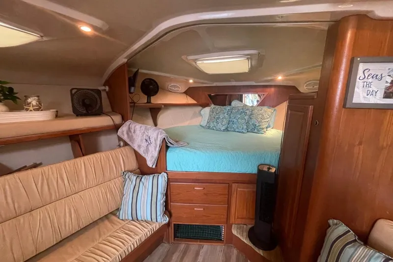 Slide: The Image of Cozy cabin interior of 1997 Luhrs 36 SX boat with bed and seating area. - 12