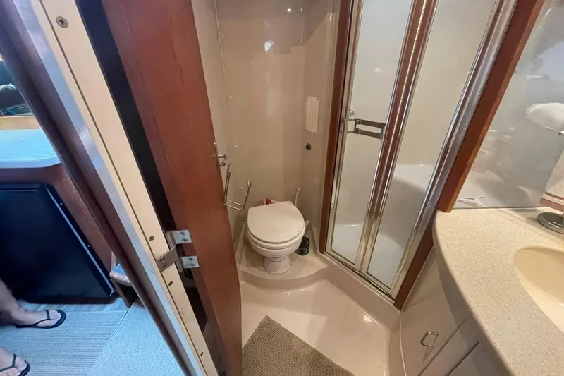 Slide: The Image of 1997 Luhrs 36 SX yacht bathroom with shower, toilet, and sink. - 16