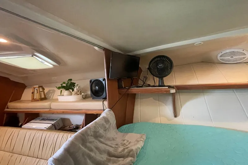 Slide: The Image of Interior of 1997 Luhrs 36 SX boat with cozy cabin, fan, and decor elements. - 22