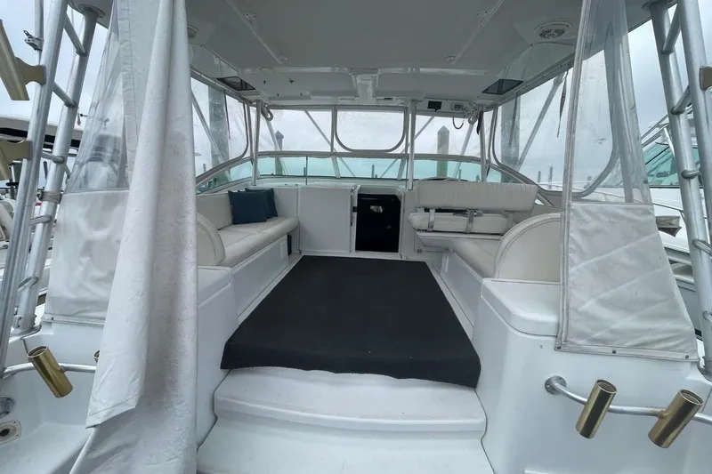 Slide: The Image of 1997 Luhrs 36 SX boat interior with seating and clear enclosures. - 24