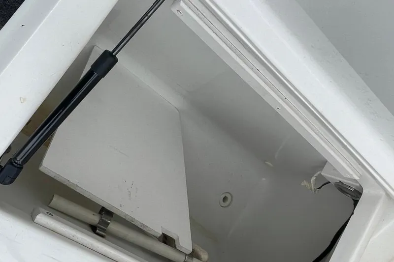 Slide: The Image of Open storage compartment on 1997 Luhrs 36 SX boat, showing interior details. - 32