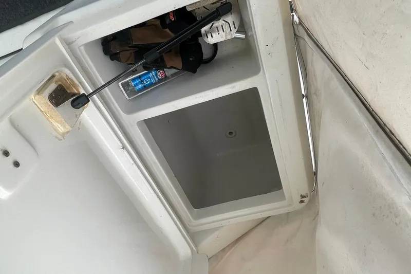 Slide: The Image of Storage compartment on a 1997 Luhrs 36 SX boat with gear and cleaning supplies. - 33