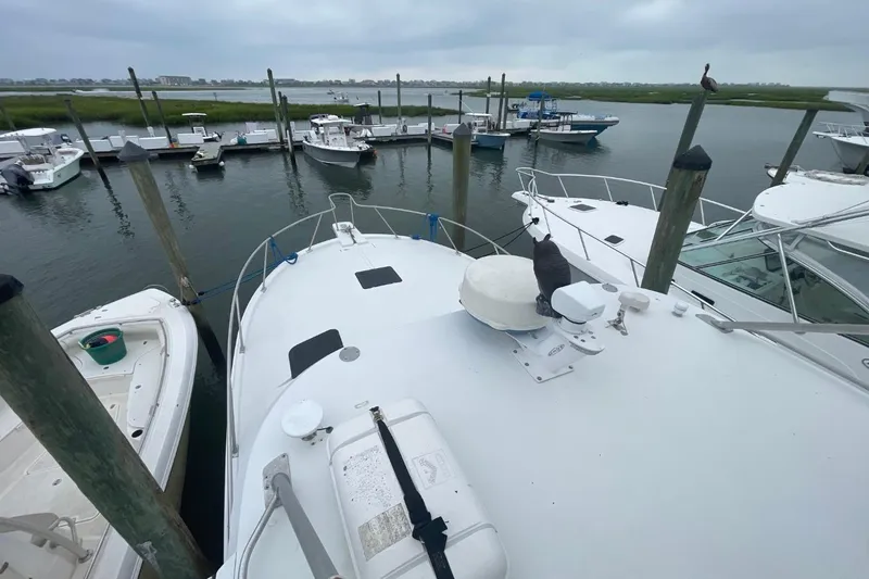Slide: The Image of 1997 Luhrs 36 SX yacht docked at marina with surrounding boats. - 43
