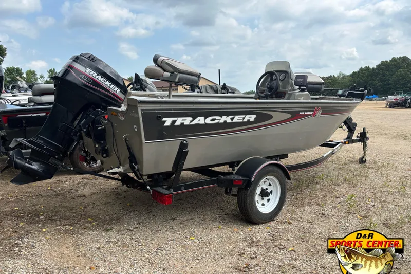 Slide: The Image of 2003 Tracker Pro Angler V 16 boat on trailer, parked outdoors. - 2