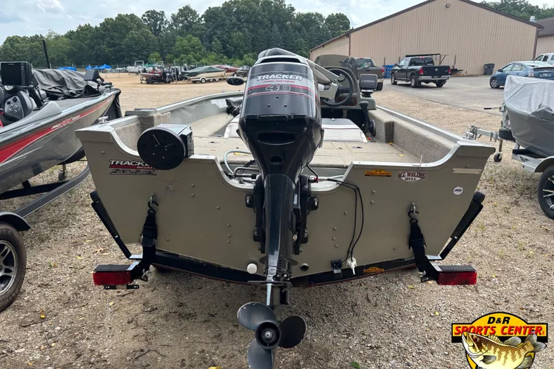 Slide: The Image of 2003 Tracker Pro Angler V 16 boat with outboard motor, parked outdoors at D&R Sports Center. - 3