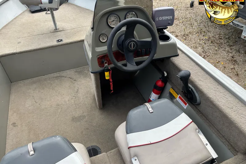 Slide: The Image of 2003 Tracker Pro Angler V 16 boat interior with steering wheel and Garmin device. - 6