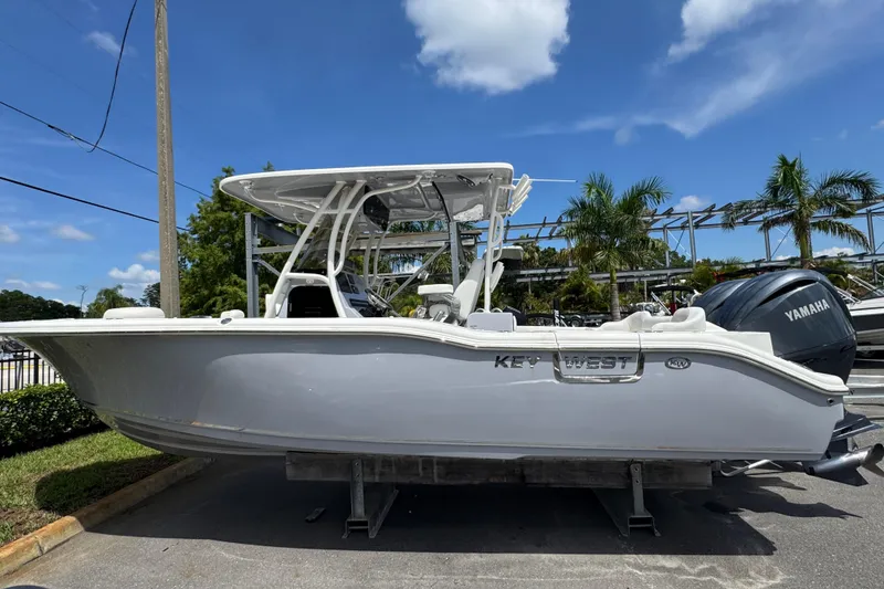 The Image of 2025 Key West 263 FS boat with Yamaha engine, parked outdoors under a clear blue sky. - 1