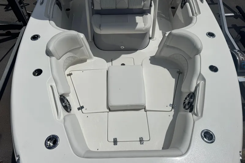 Slide: The Image of 2025 Key West 263 FS boat interior with white seating and cup holders. - 14