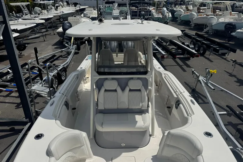 Slide: The Image of 2025 Key West 263 FS boat in marina, showcasing sleek design and spacious seating. - 15