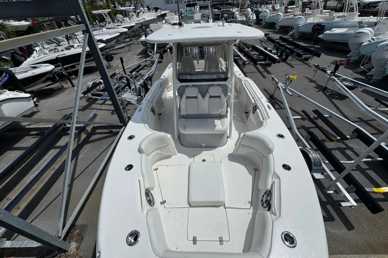 Slide: The Image of 2025 Key West 263 FS boat in a marina, surrounded by trailers and other boats. - 16