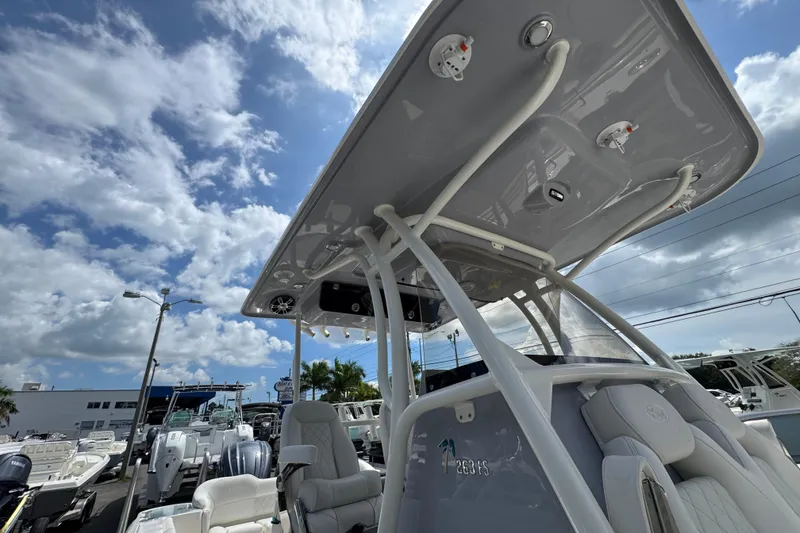 Slide: The Image of 2025 Key West 263 FS boat with T-top under a partly cloudy sky. - 18