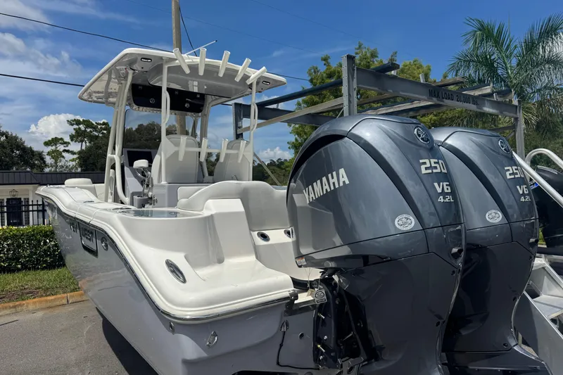 Slide: The Image of 2025 Key West 263 FS boat with dual Yamaha 250 V6 engines, parked outdoors. - 3